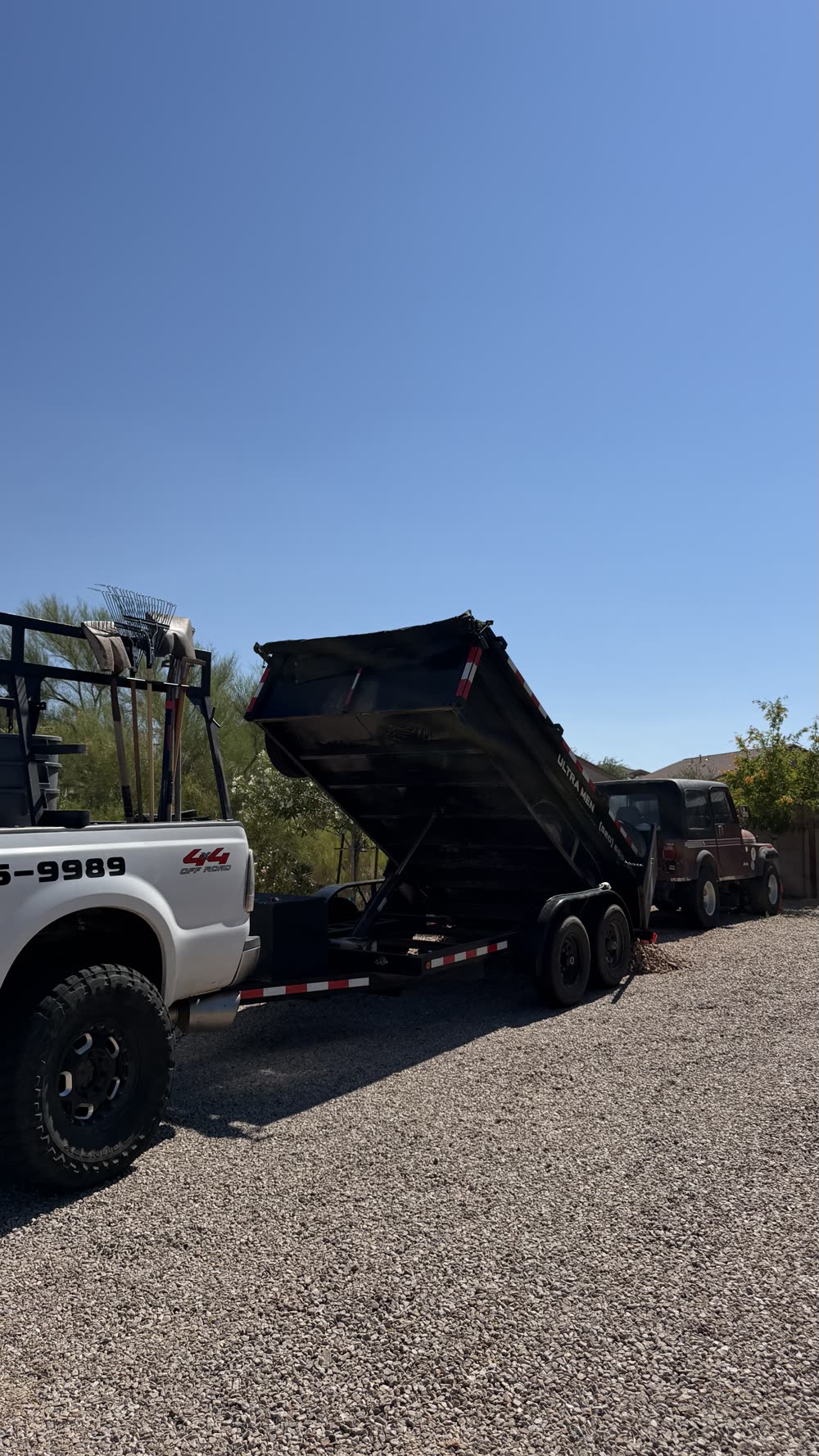 Ultra Men Property Services dump trailer on a Tucson job site