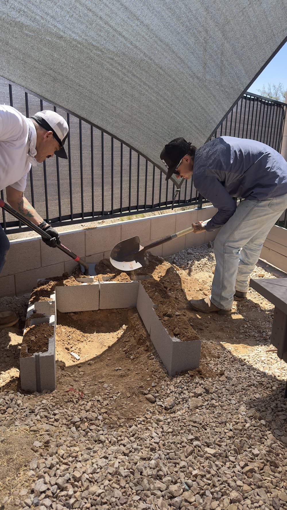Ultra Men crew building a block fire pit in a Tucson backyard