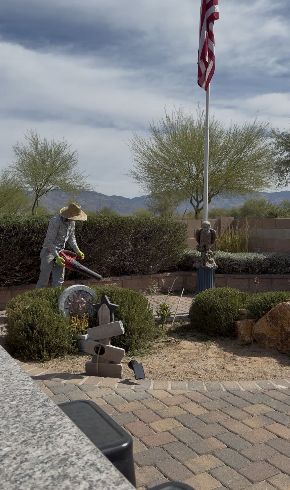 Crew member detailing a Tucson front yard with paver walkways