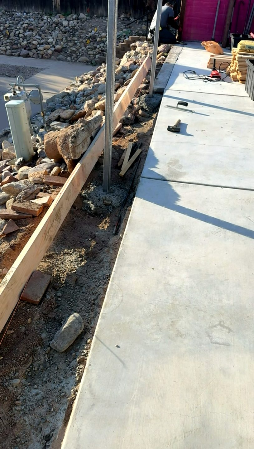 Fresh concrete work along a Tucson fence line by Ultra Men