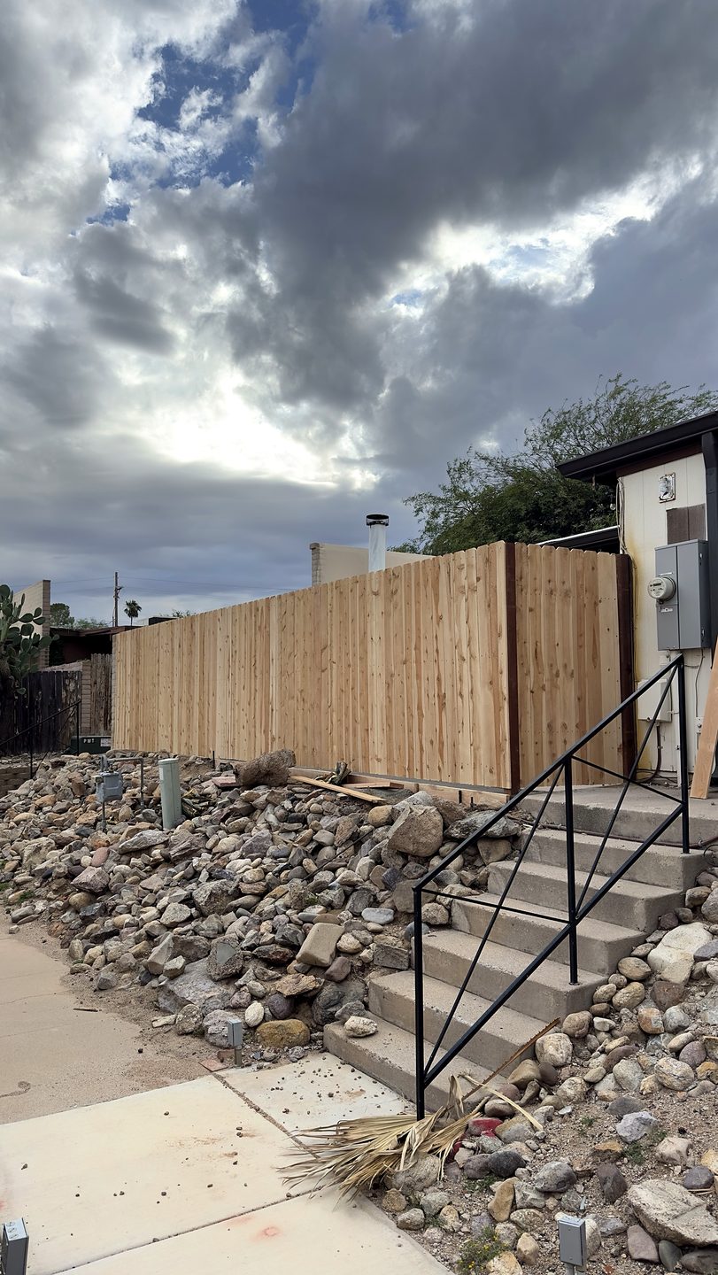 Installing rails and pickets on a new wood fence in Tucson