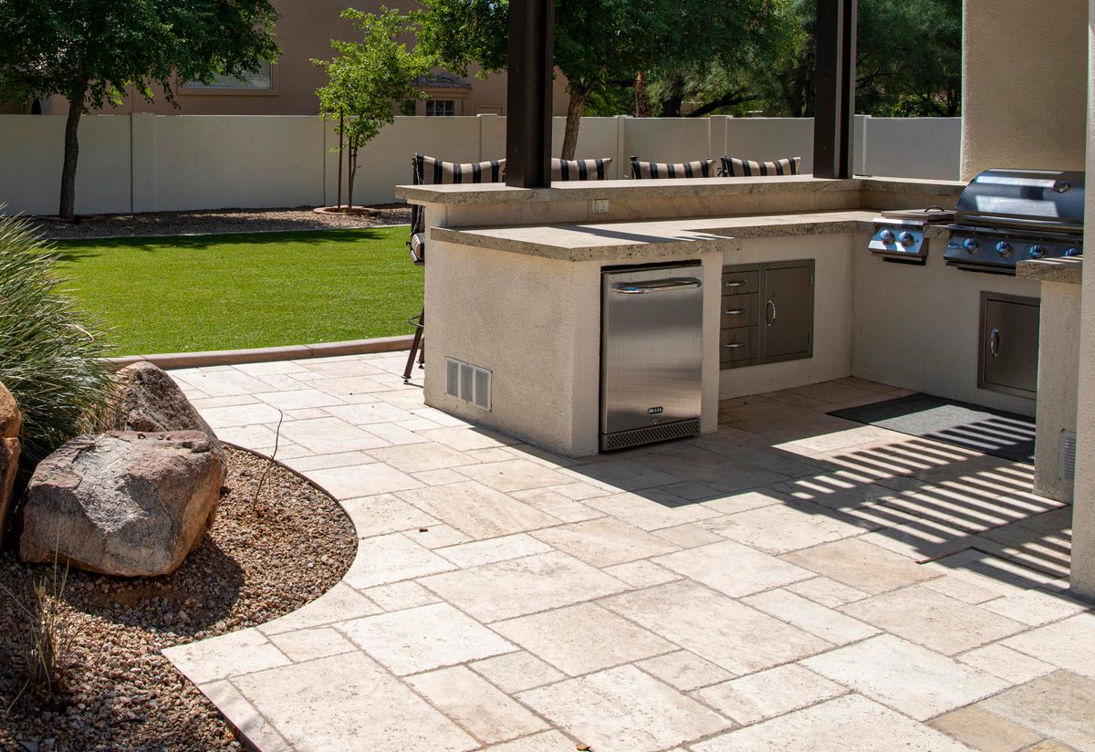 Travertine paver patio with desert landscaping in an Arizona backyard